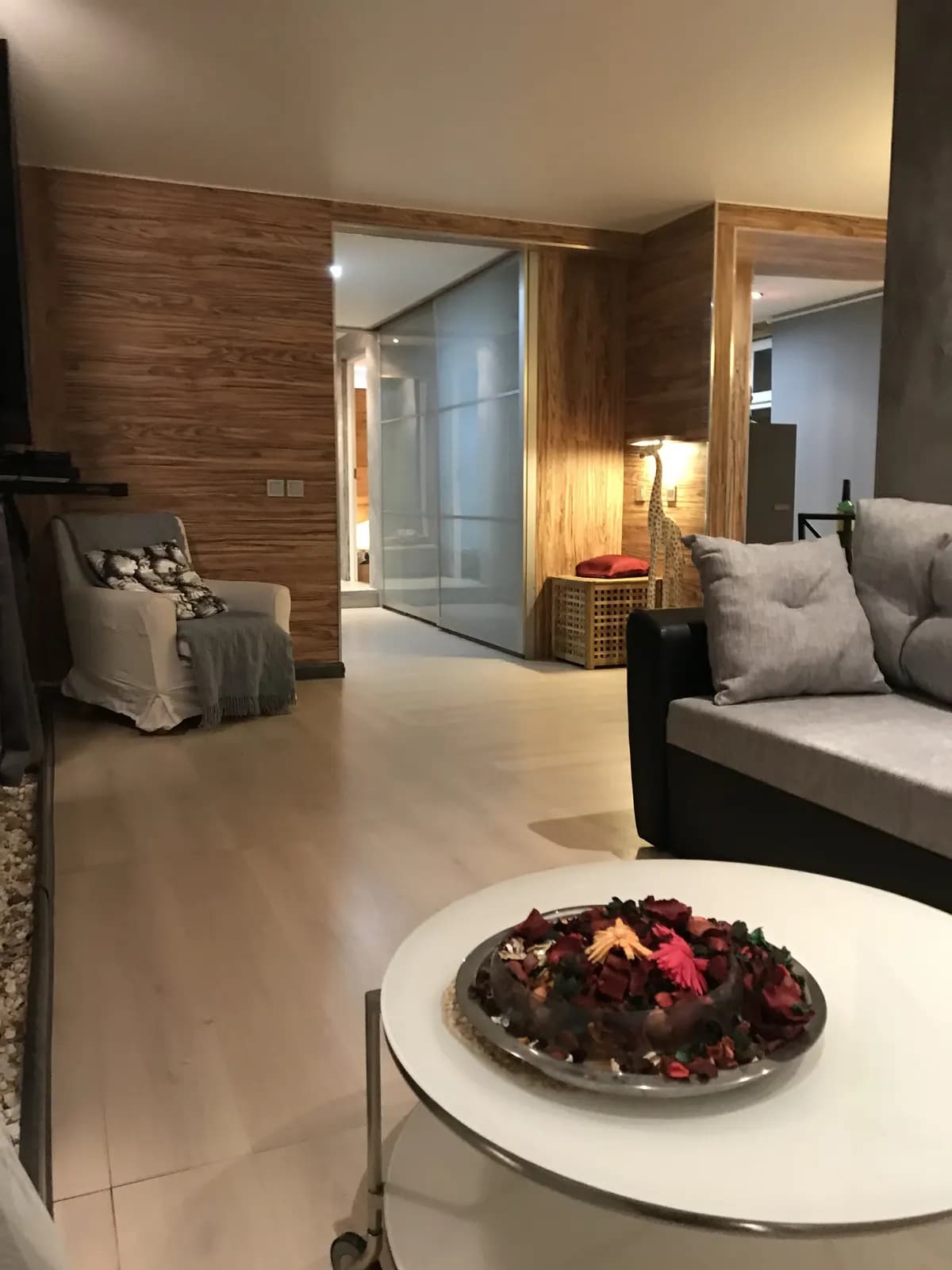 Open living room with frosted glass partitions and soft neutral furnishings